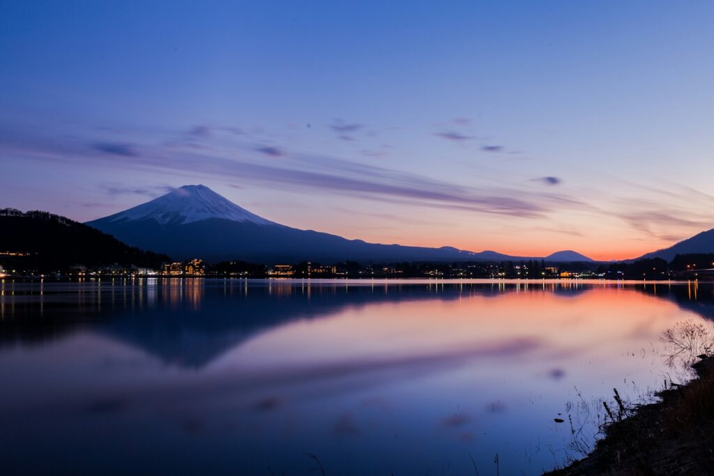 Mount Fuji reflected in calm water in Kawaguichiko