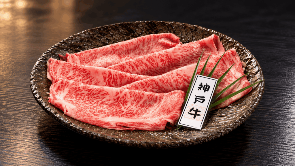 Thin slices of highly marbled Kobe Beef arranged on a ceramic plate
