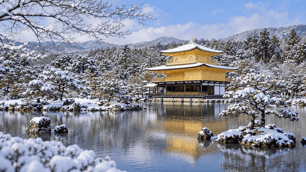 Golden Pavilion of Kinkakuji Temple reflected in a pond surrounded by snow-covered trees and gardens in Kyoto