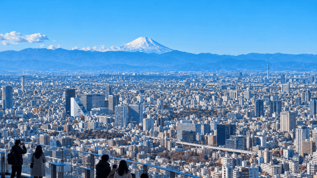 Panoramic view of snow-capped Mount Fuji and the Tokyo skyline, including Tokyo Skytree, on a clear winter day