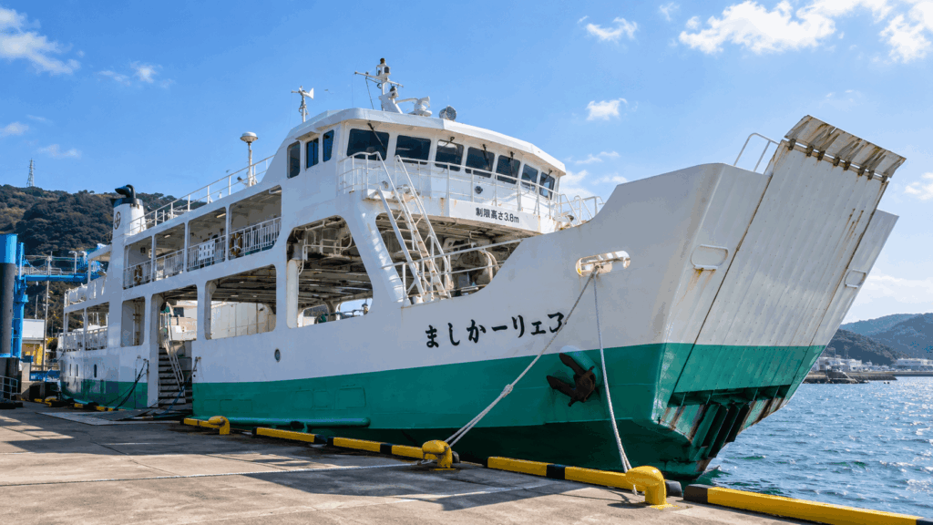 White and green ferry docked at a harbor for the journey to Ikeshima Island in Nagasaki, Japan