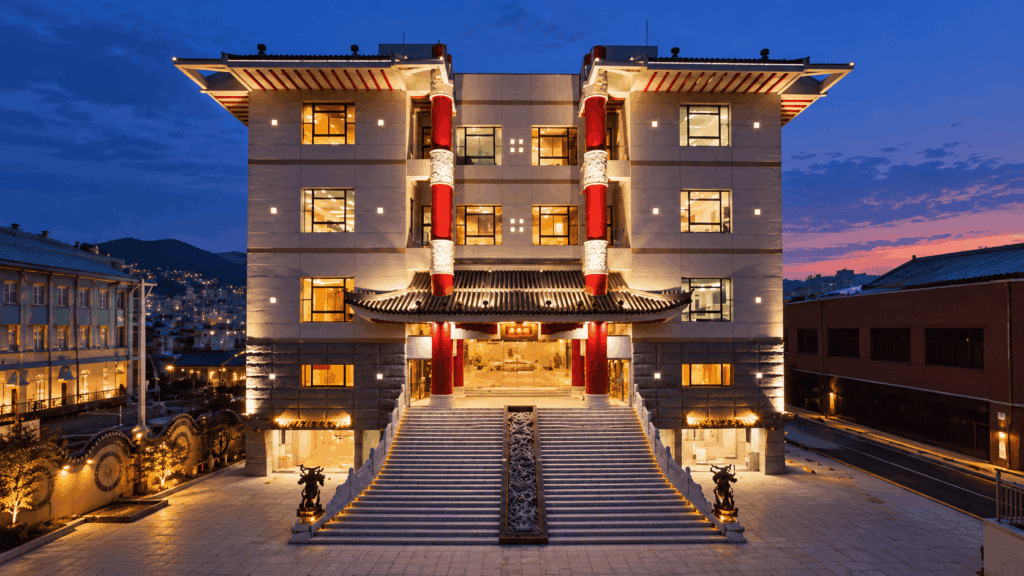 Shikairo Chinese restaurant in Nagasaki illuminated at dusk, featuring traditional Chinese-style architecture and a grand entrance