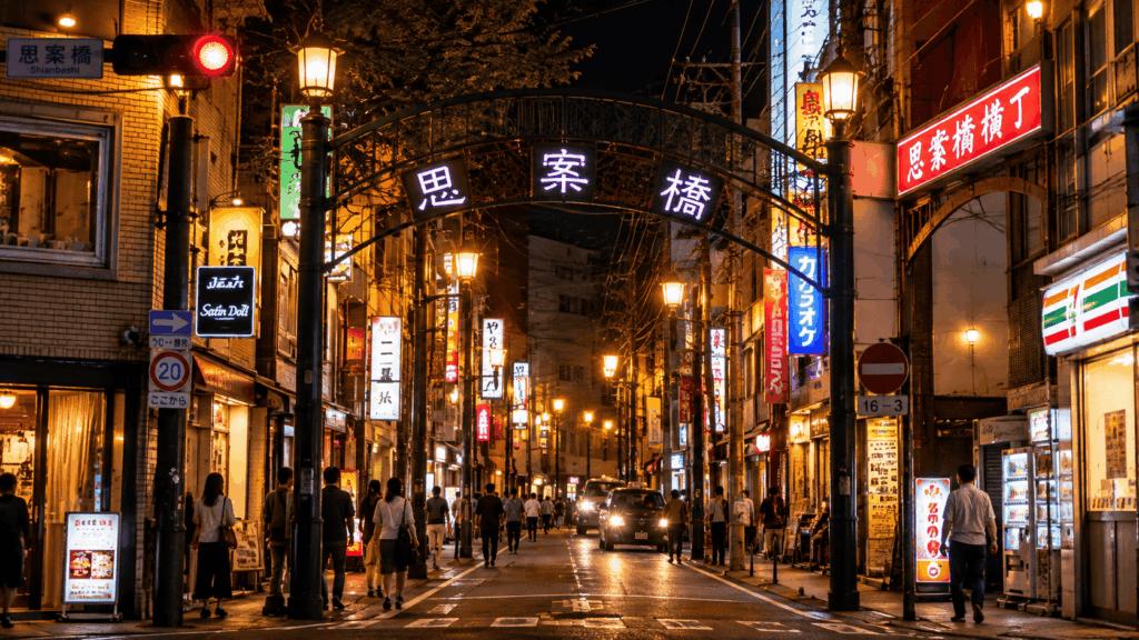 Shianbashi nightlife district in Nagasaki at night, with a neon-lit entrance arch, restaurants, bars, and pedestrians