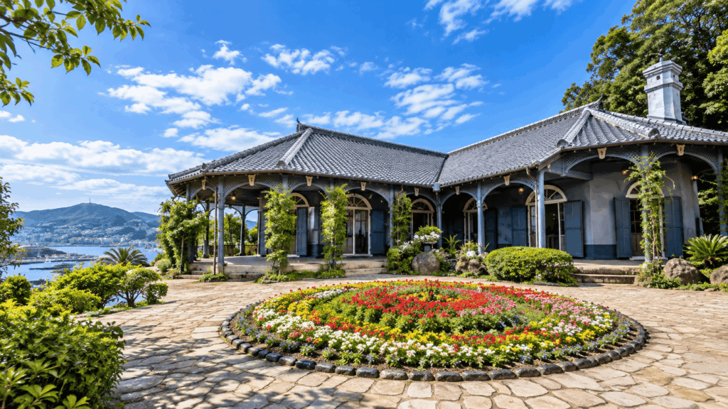 Historic Western-style residence at Glover Garden in Nagasaki, surrounded by colorful flower beds with views of Nagasaki Harbor